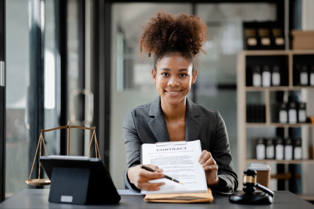 American lawyer sits in a law firm, female lawyer holding a contract document.